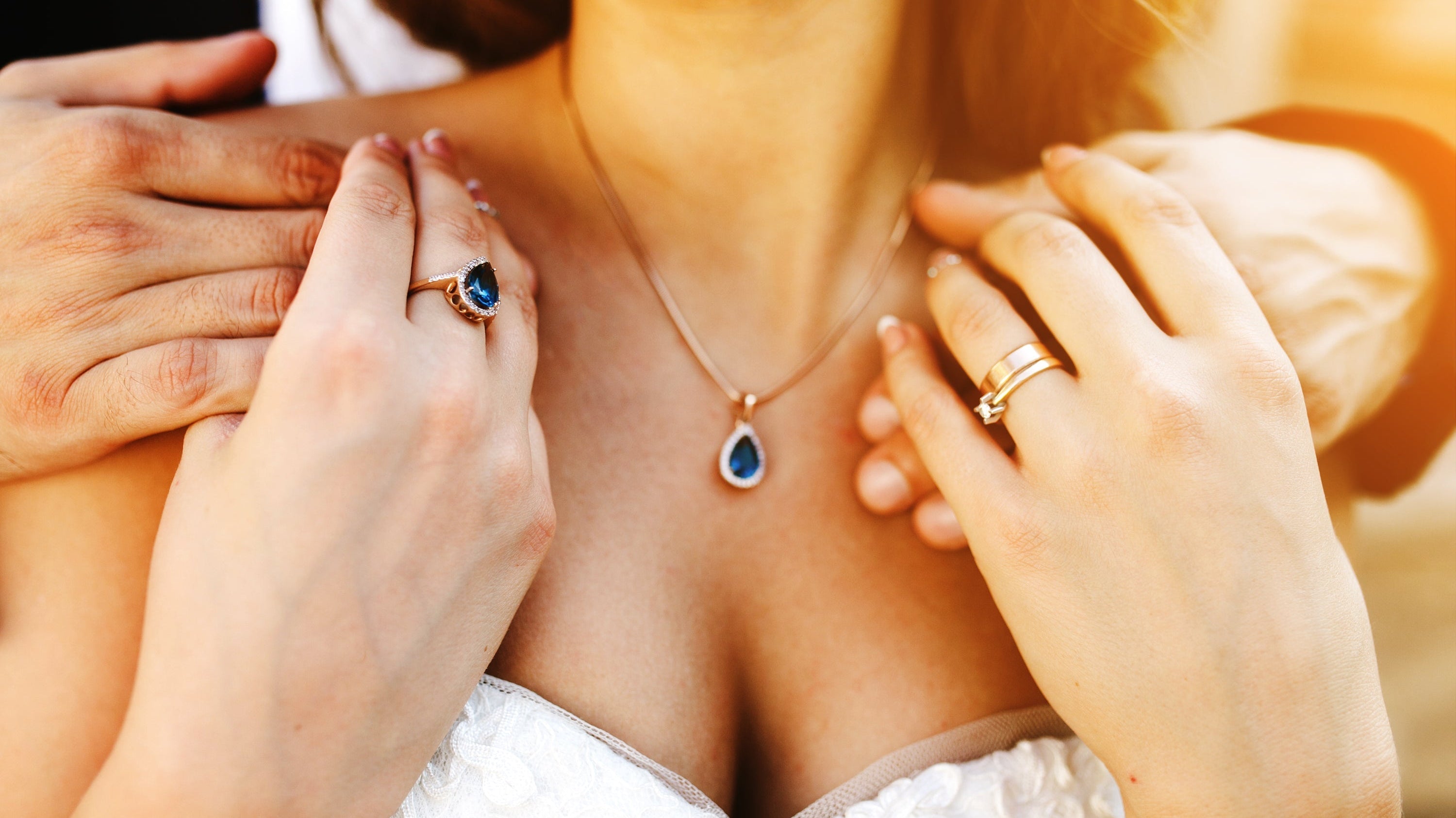 Fine jewellery with sapphire necklace and rings on bridal outfit
