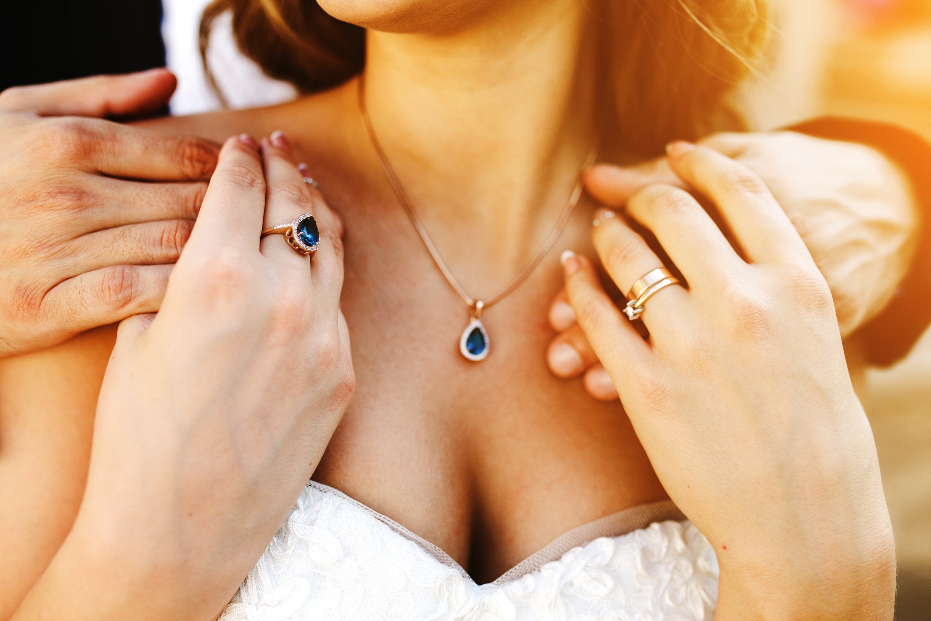 Fine jewellery with sapphire necklace and rings on bridal outfit