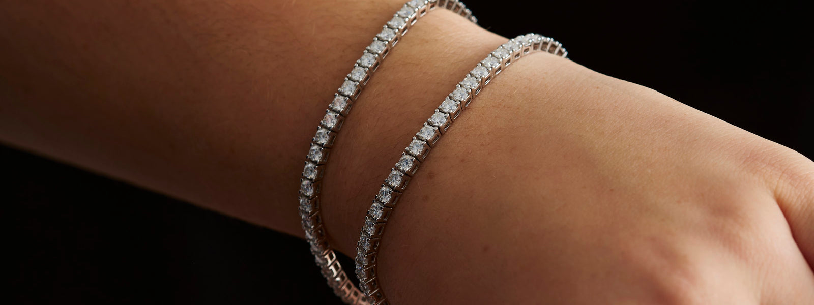 Two Prism & Pearl moissanite tennis bracelets stacked on the wrist
