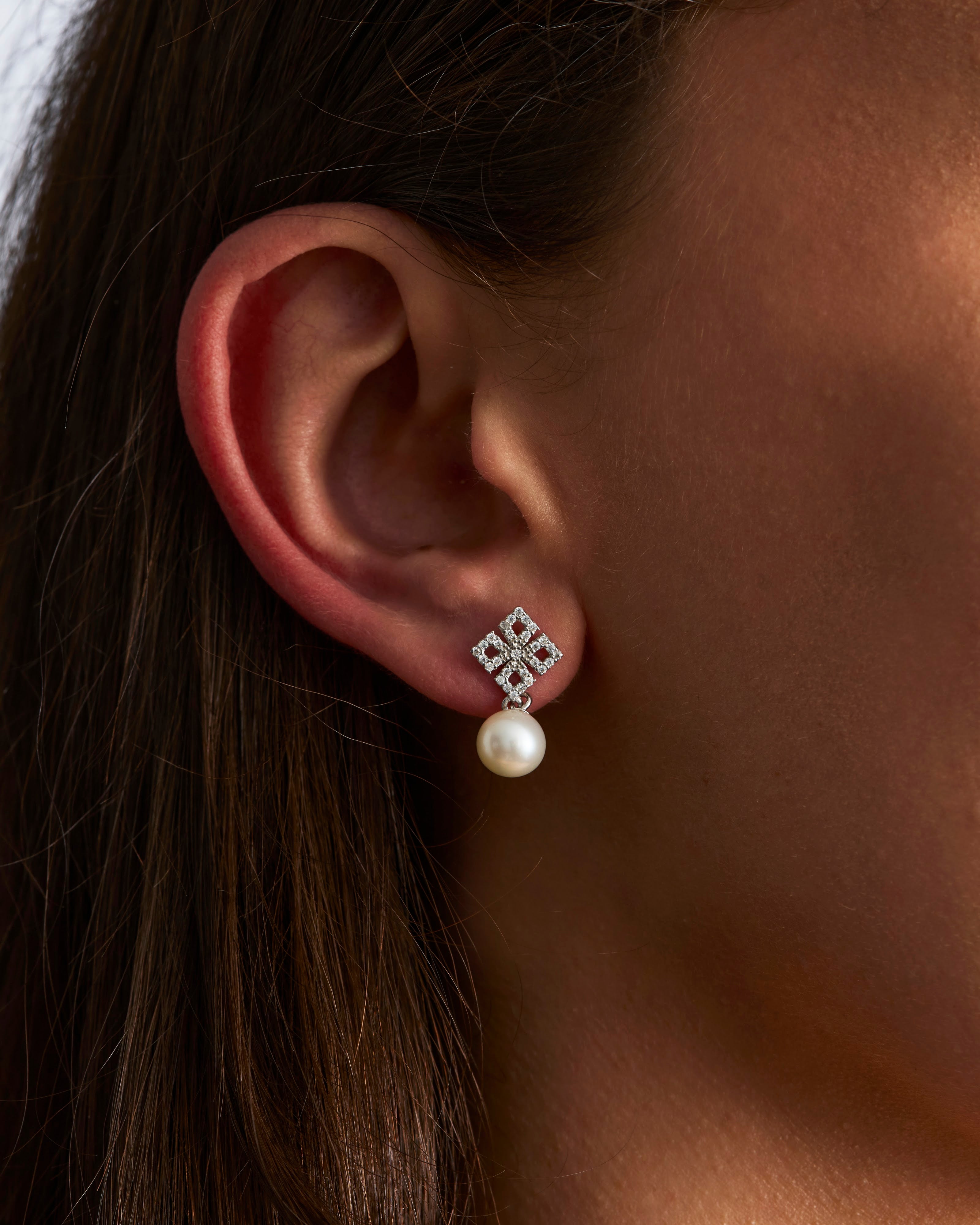 Pearl and moissanite drop earring worn
