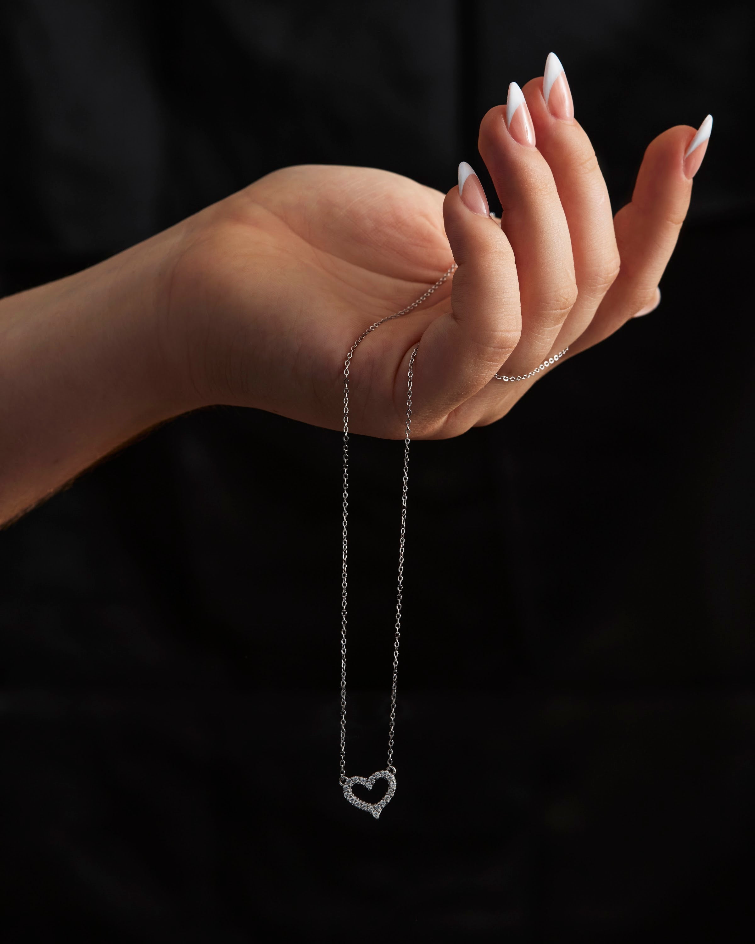 Étoile Pavé Heart Necklace held in hand to show scale