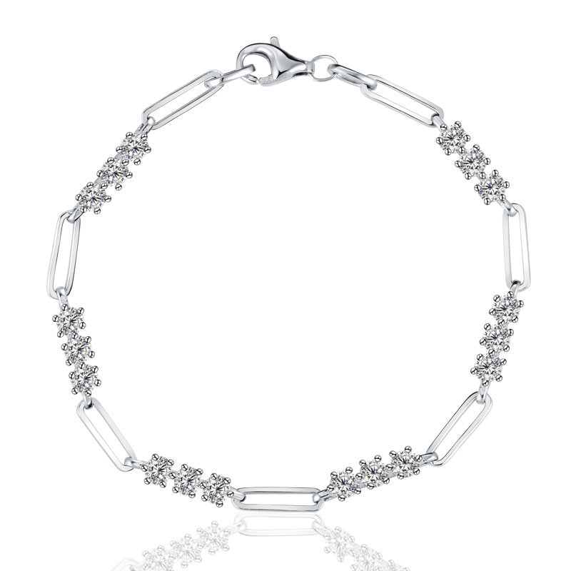 Silver bracelet with paperclip links and diamond accents on a white background