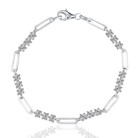 Silver bracelet with paperclip links and diamond accents on a white background