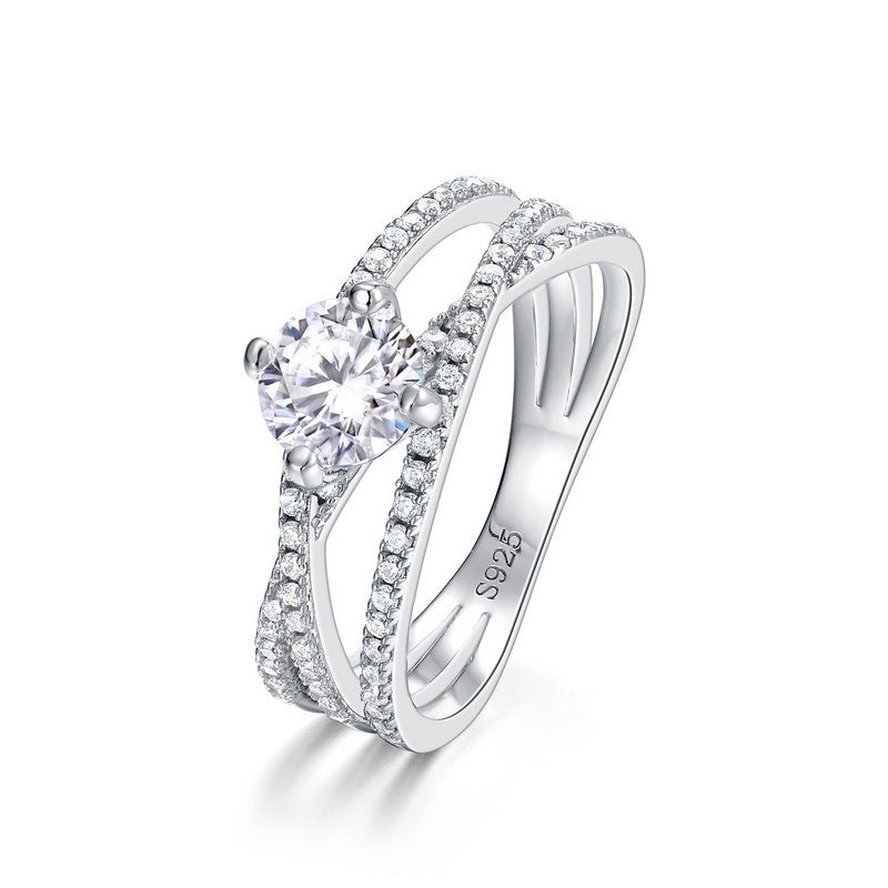Solitaire moissanite cross band ring with pavé shoulders in sterling silver.