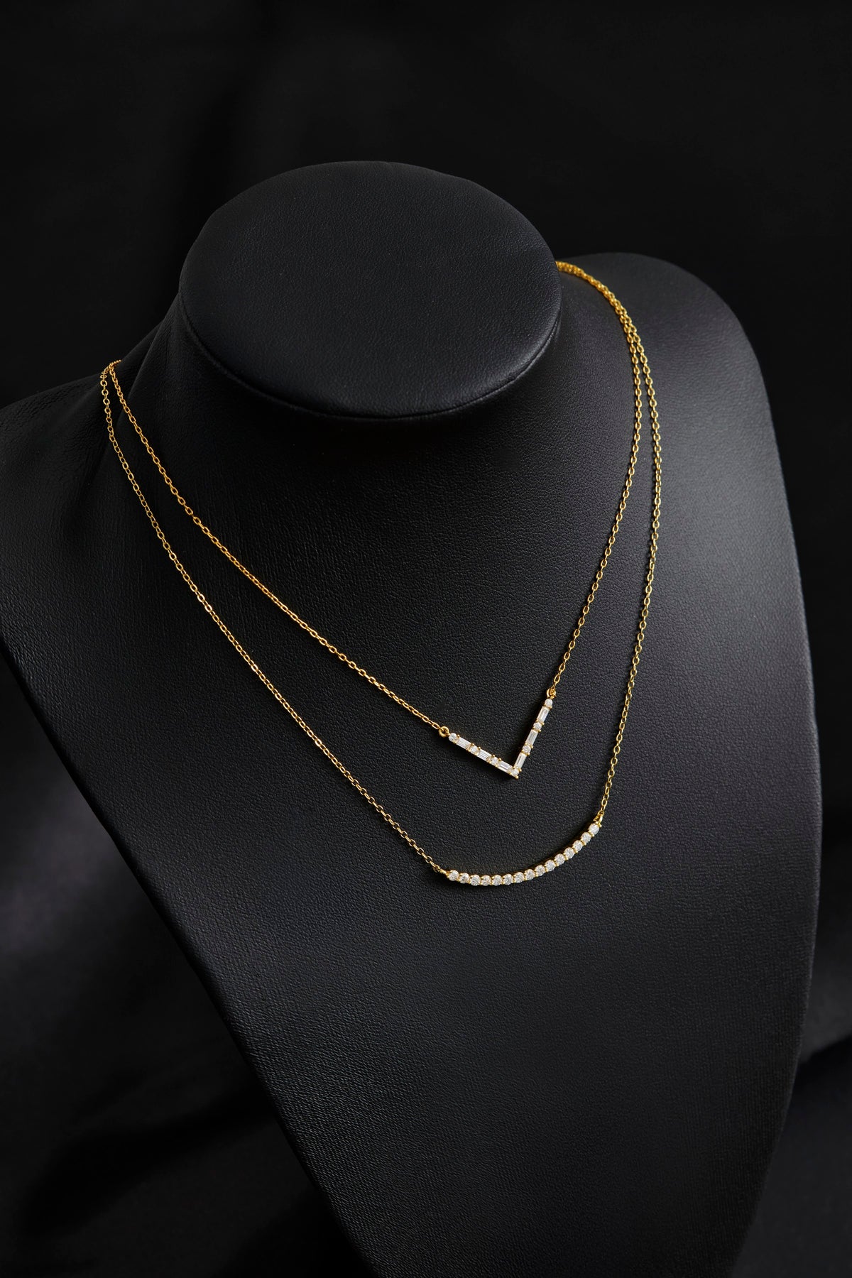 Axelle Pave V Necklace in gold on a display bust