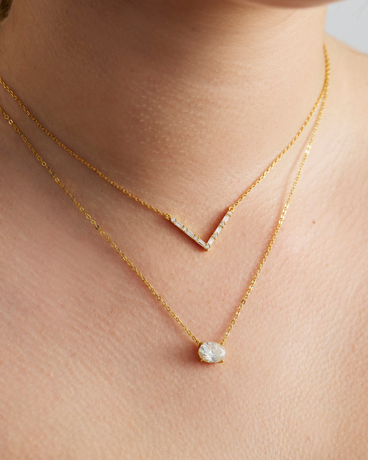 Axelle Pave V Necklace in gold, worn layered