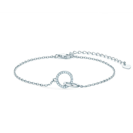 Silver bracelet with interlocking circles with pavé moissantes on a white background