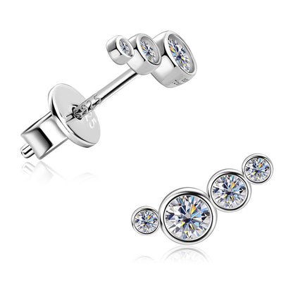 Silver earrings with clear gemstones on a white background