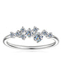 Cluster moissanite ring on a slim sterling silver band.