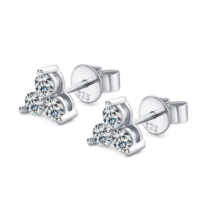 Pair of silver stud earrings with a trio of moissanite gemstones on a white background