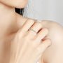 Daisy Moissanite Bamboo style ring on finger of girl who is out of picture