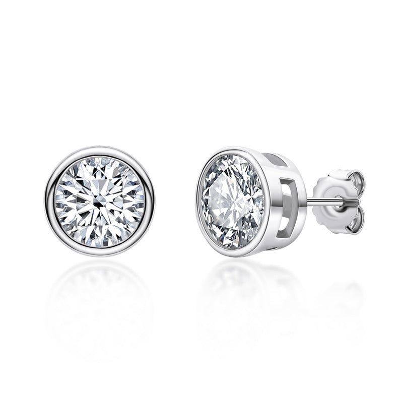 Pair of silver stud earrings with moissanite bezel set gemstones on a white background