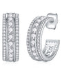 Silver three channel hoop earrings with clear moissanite stones on a white background
