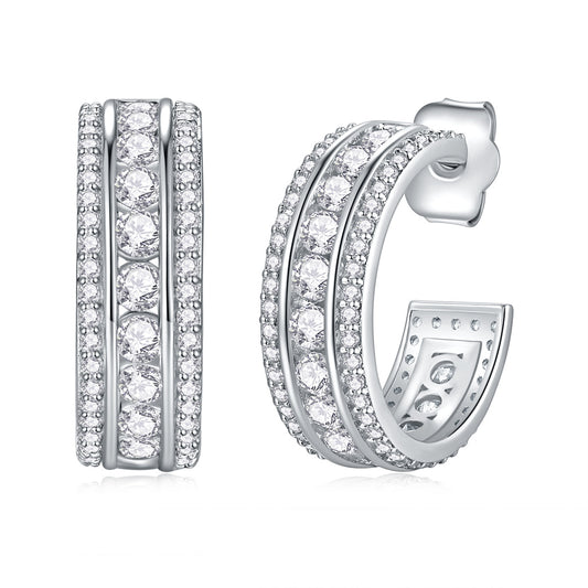 Silver three channel hoop earrings with clear moissanite stones on a white background