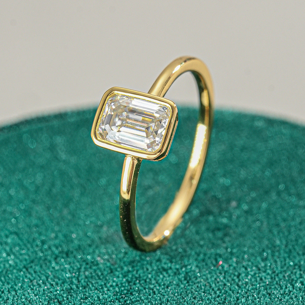 Hannah Emerald Cut Bezel Solitaire Side View on green ring box close up