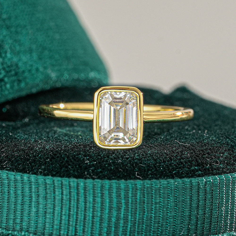 Hannah Emerald Cut Bezel Solitaire in green ring box