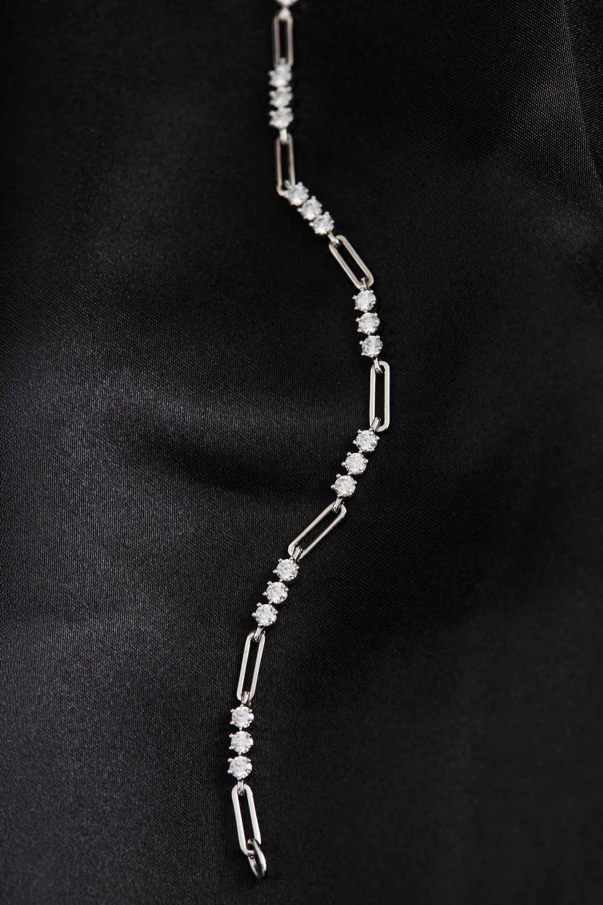 Heloise Gem Link Bracelet laid flat on black fabric