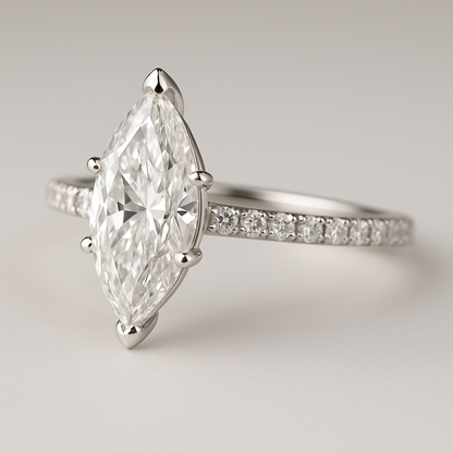 Diamond ring with a marquise-shaped center stone on a light gray background