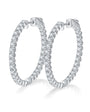 Pair of silver hoop earrings with 1.56ct of moissanite gemstones on a white background