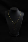 Lumiere Bezel Y Necklace in gold on a display bust