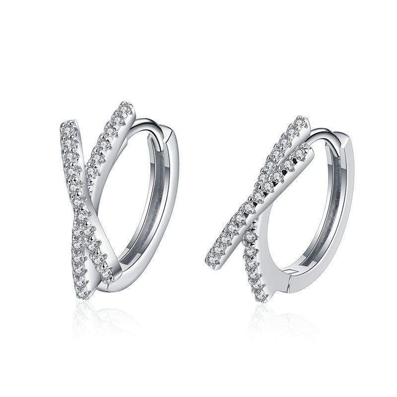 Pair of silver hoop earrings with pavé diamonds on a white background