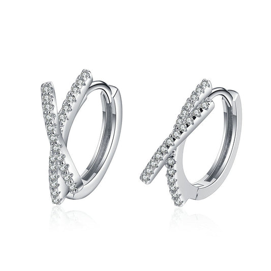 Pair of silver hoop earrings with pavé diamonds on a white background