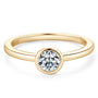 The Maxine Solitaire Bezel Ring in gold on white background