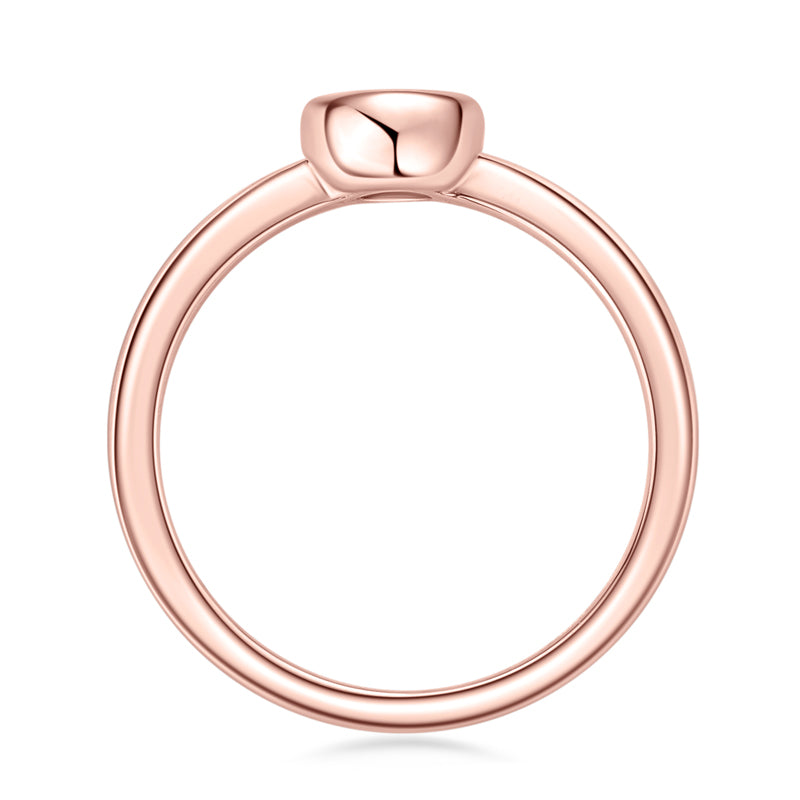 Rose gold bezel set diamond ring on a white background prism and pearl