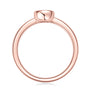 Rose gold bezel set diamond ring on a white background prism and pearl