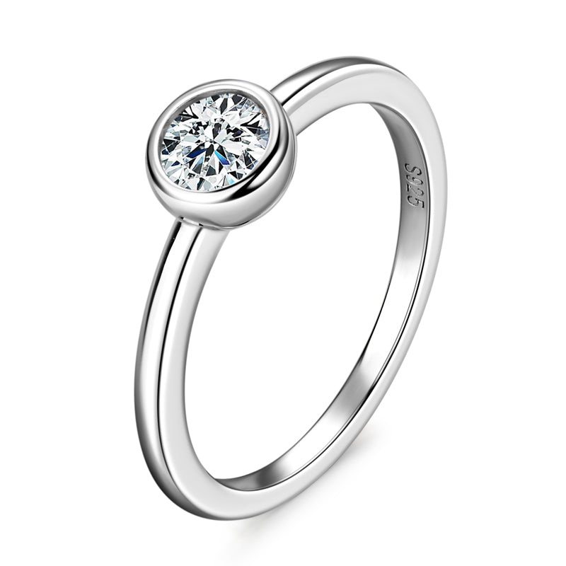 The Maxine Solitaire Bezel Ring Silver ring with a diamond on a white background p rism and pearl
