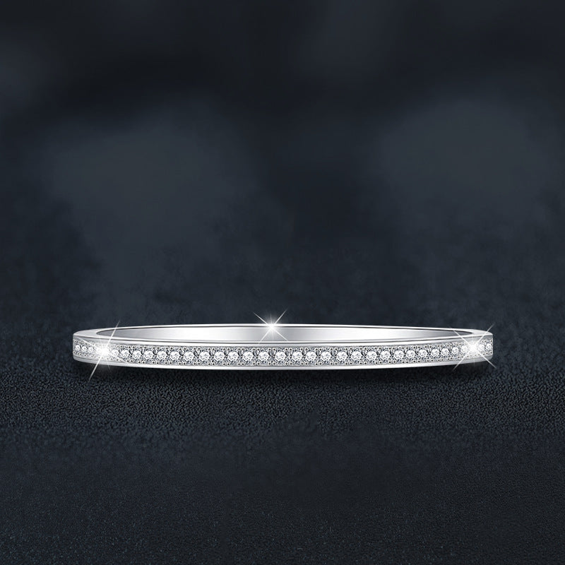 Silver bracelet with moissanite small stones on a dark background