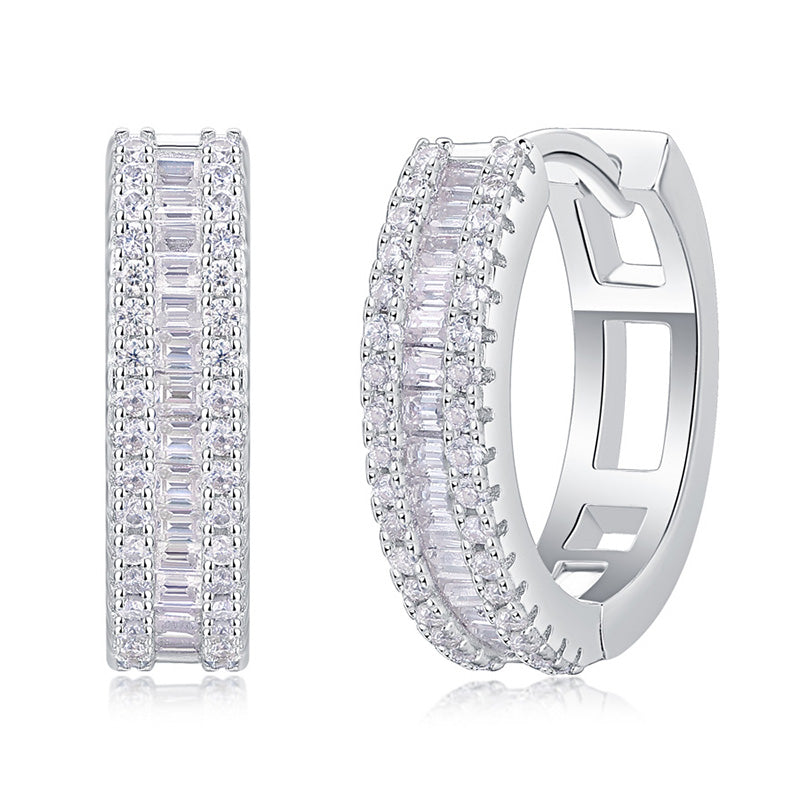 Pair of silver hoop earrings with clear gemstones on a white background