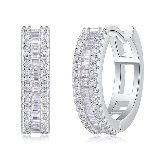 Pair of silver hoop earrings with clear gemstones on a white background