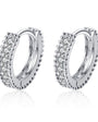 Silver hoop earrings with clear gemstones on a white background