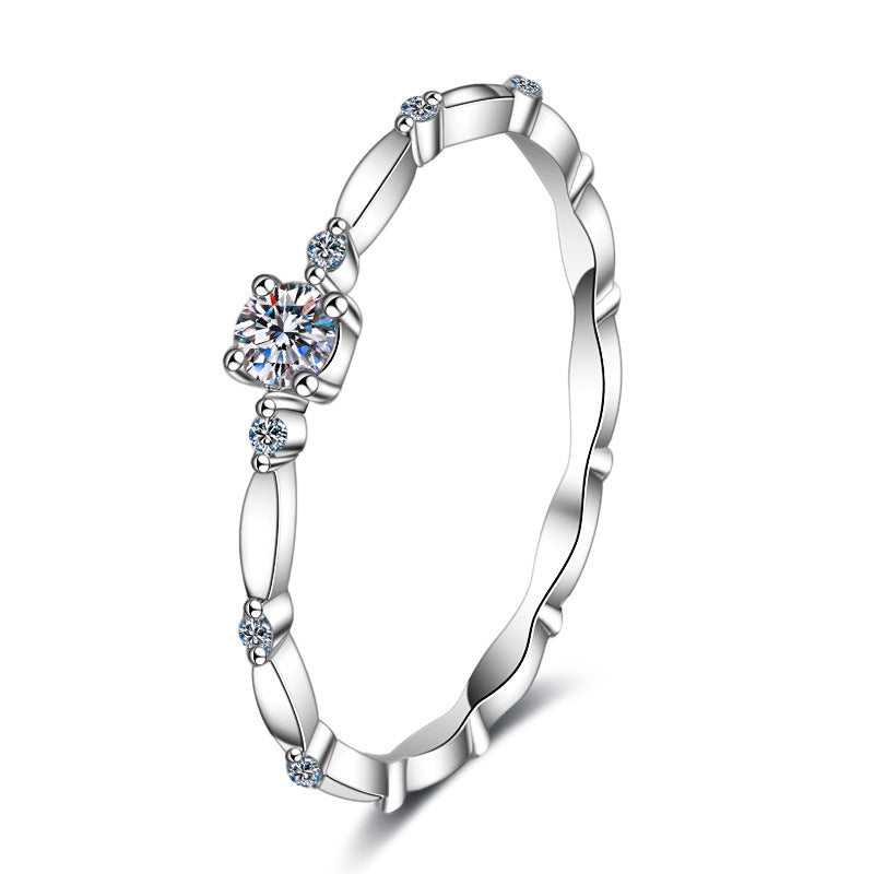 Single stone moissanite stacker ring in sterling silver.