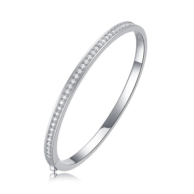 Silver bangle with pavé moissanite on a white background