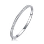Silver bangle with pavé moissanite on a white background