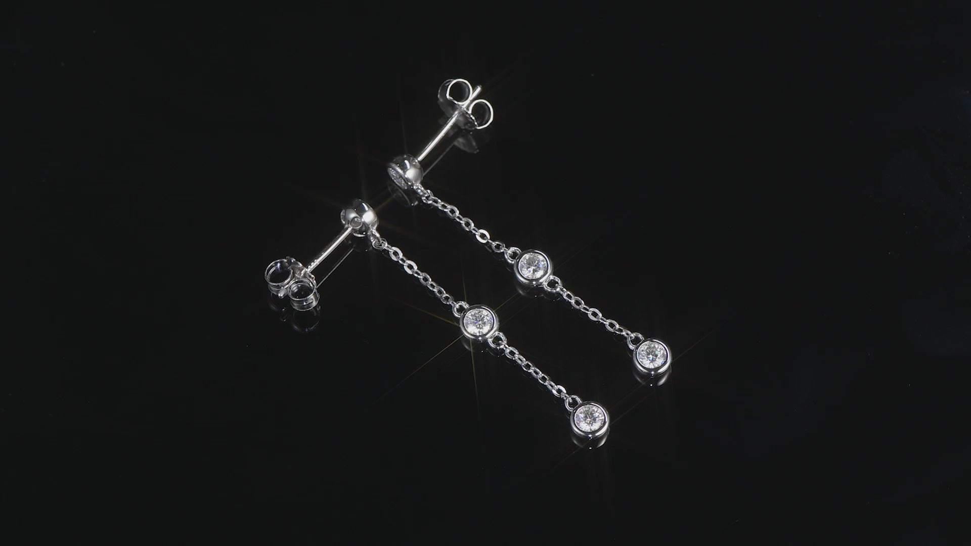 Video of Coralie Three Stone Bezel Drop Earrings on Black background
